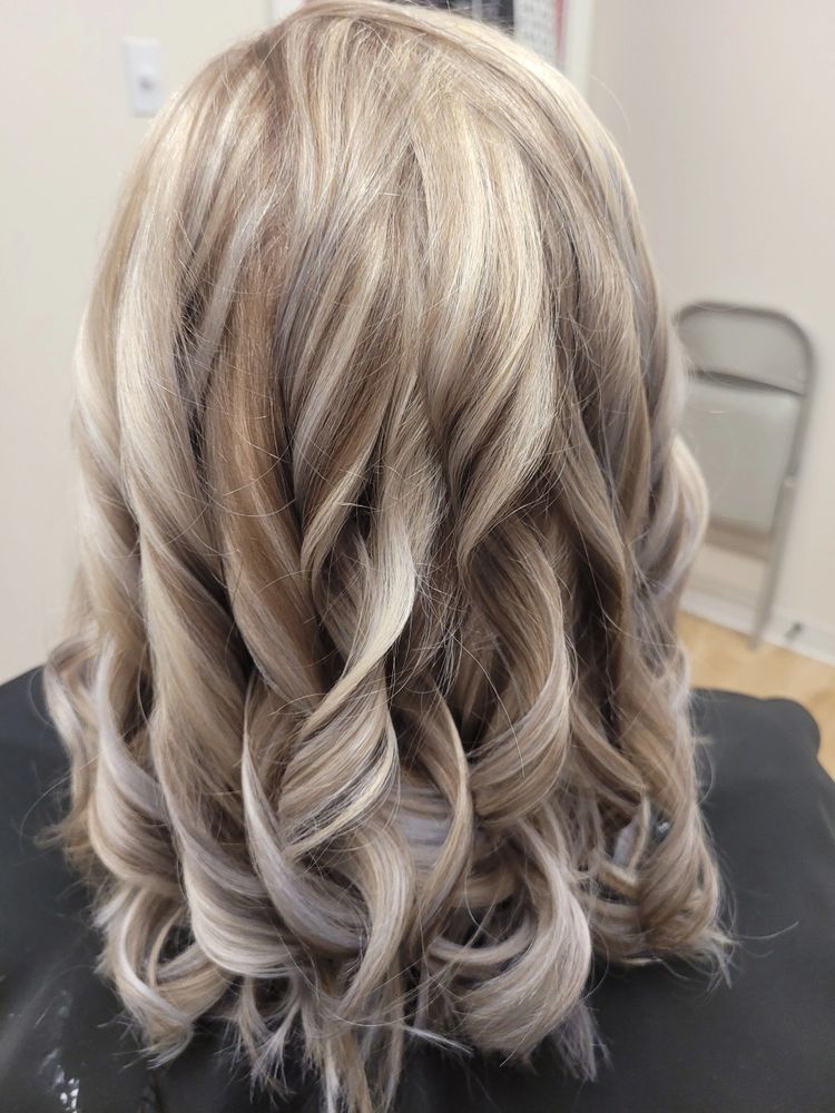 After — Faded, grown-out blonde refreshed with dimensional highlights and a soft, bouncy blowout.