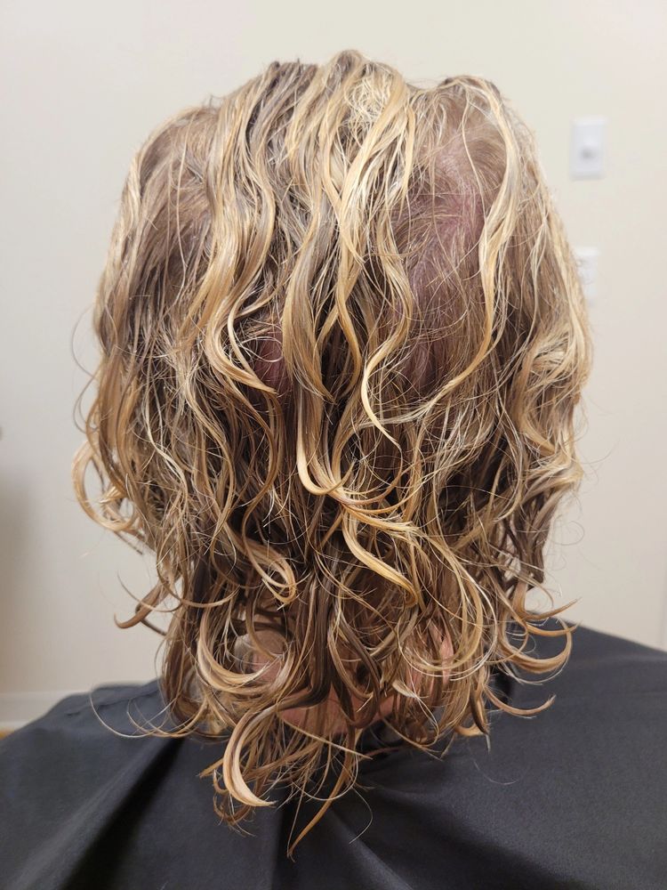 Before — Wispy, undefined layers reshaped into voluminous, springy curls with a precision cut.